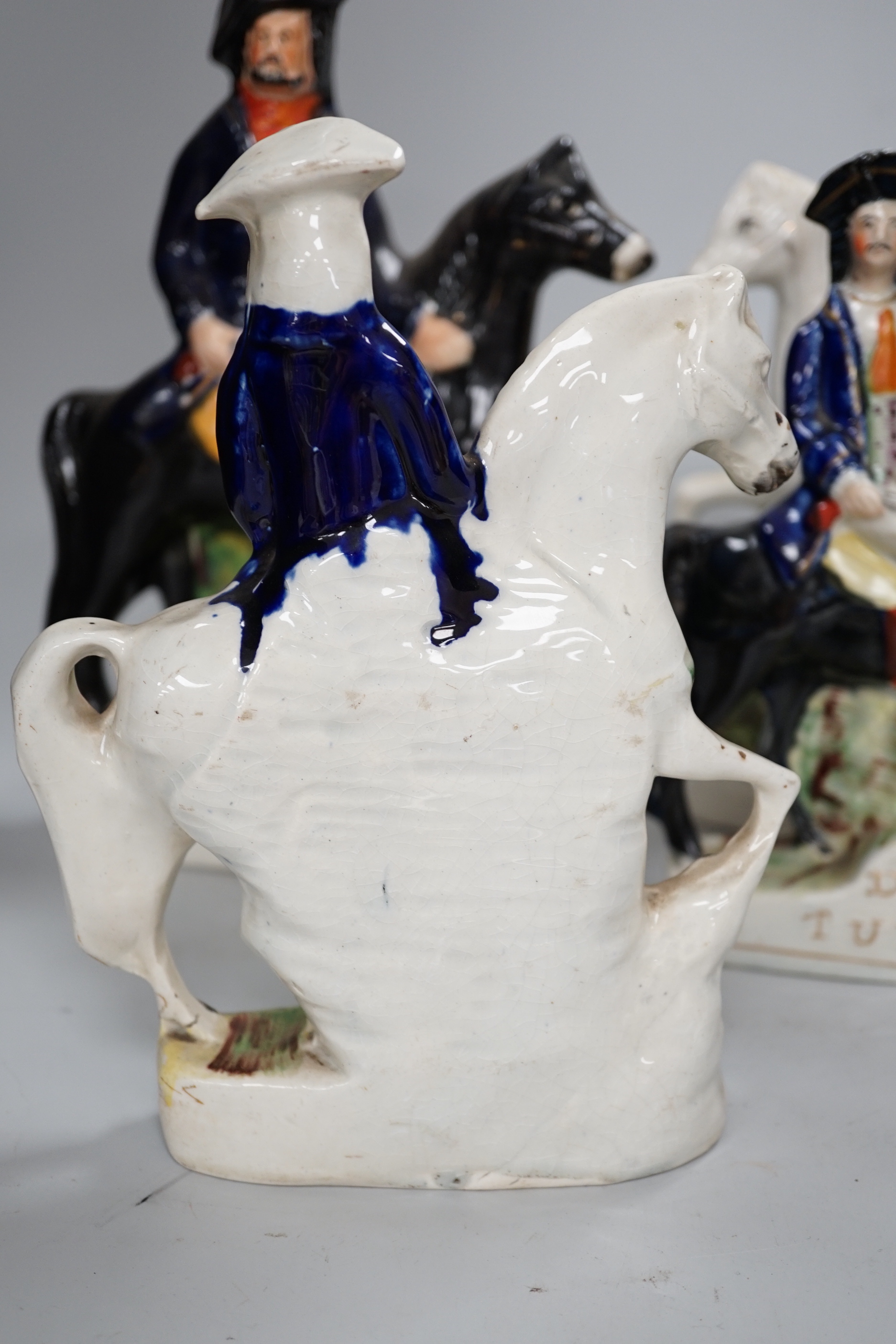 Two pairs of Staffordshire highwaymen figure groups of Tom King and Dick Turpin, the largest 30cm high